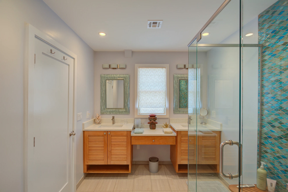 Elegant Key West bathroom renovation featuring double vanity with premium wood cabinetry and custom glass shower