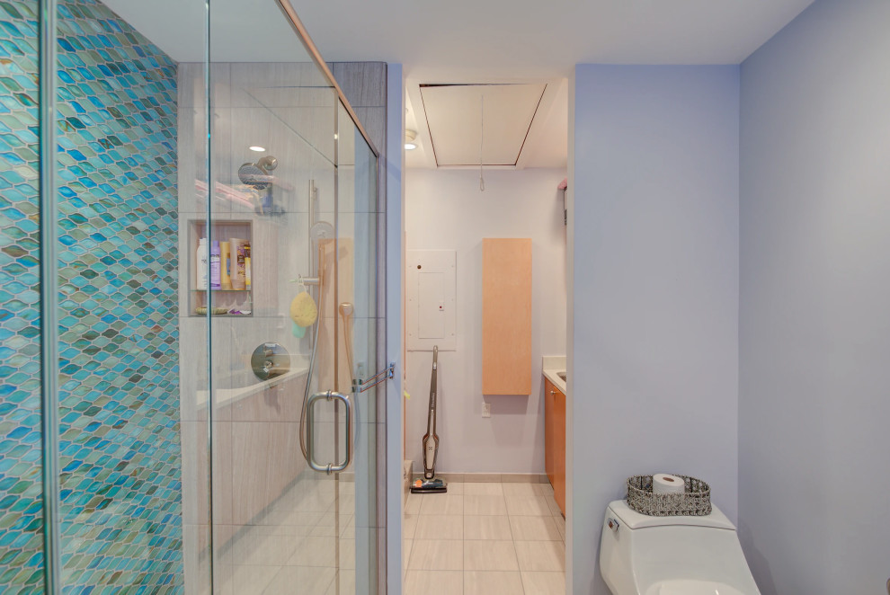 Contemporary Key West bathroom renovation with custom blue and white tiling and frameless glass shower enclosure