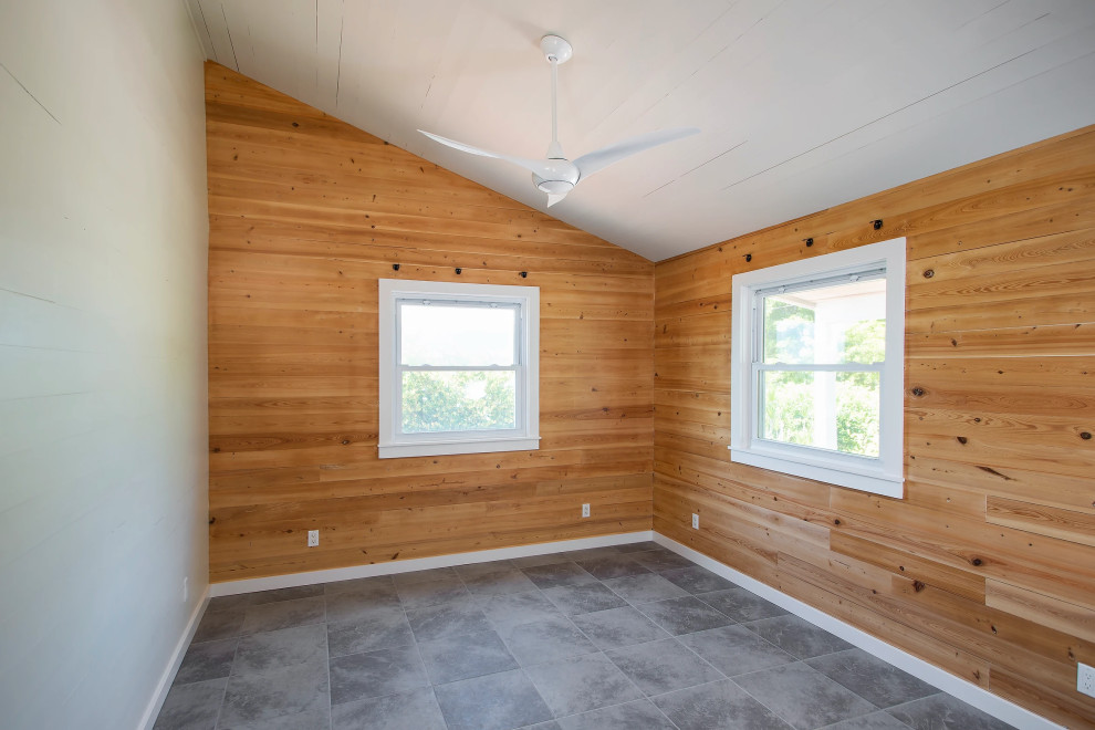 High-end Key West bedroom renovation with custom wood paneling, premium tiled flooring, and architectural window treatments