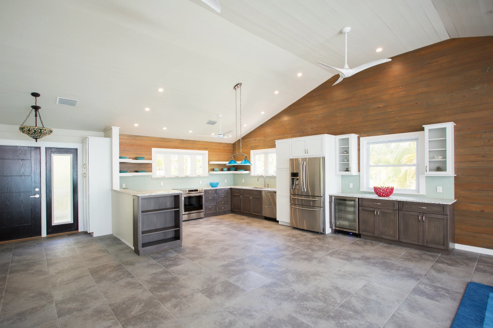 Luxurious Key West kitchen renovation featuring custom wood paneling, high-end stainless steel appliances, and designer island workspace