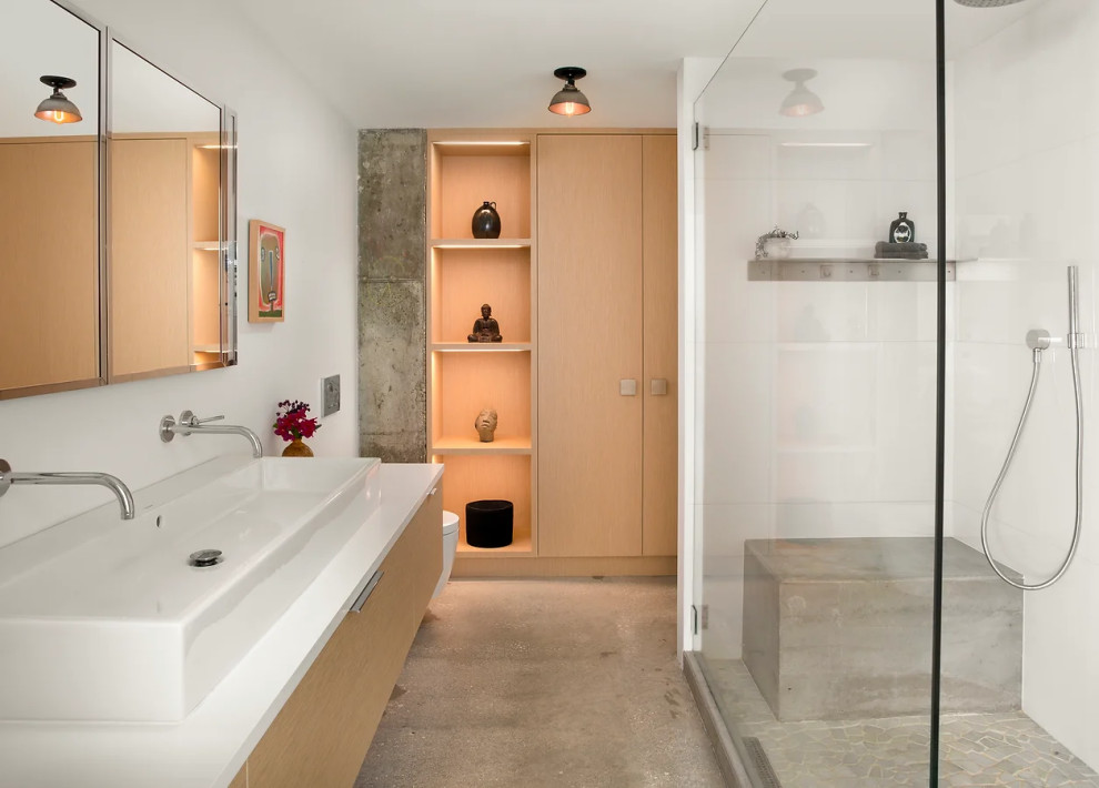 Sleek modern bathroom with floating vanity and glass shower in Key West new construction