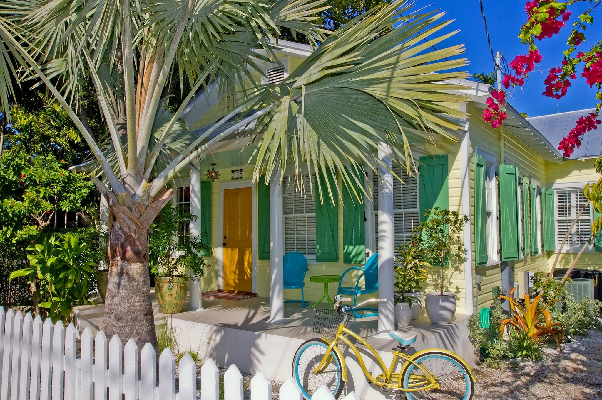 Charming yellow Key West home with green shutters renovated by Fogarty Builders