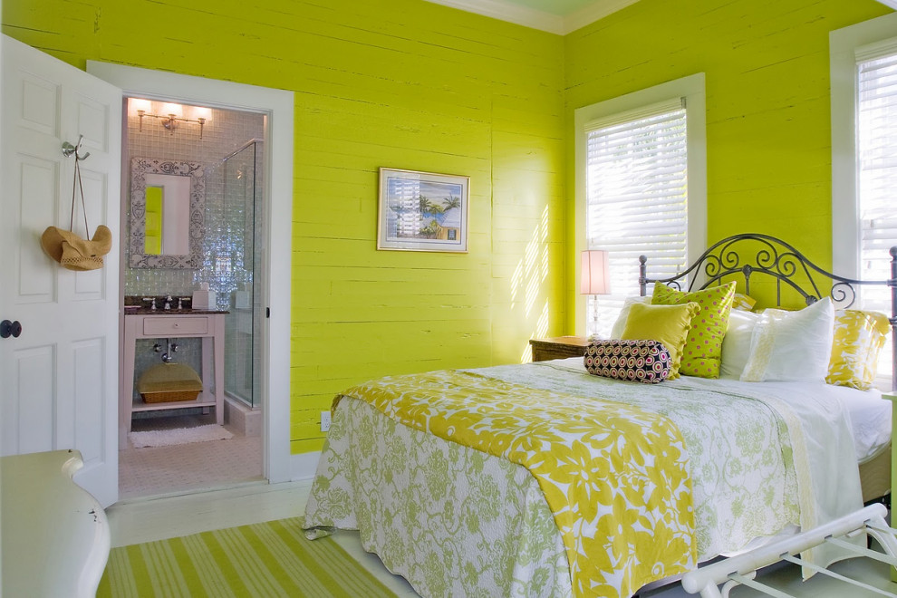 Bright bedroom with yellow walls and custom metal bedframe in Key West renovation