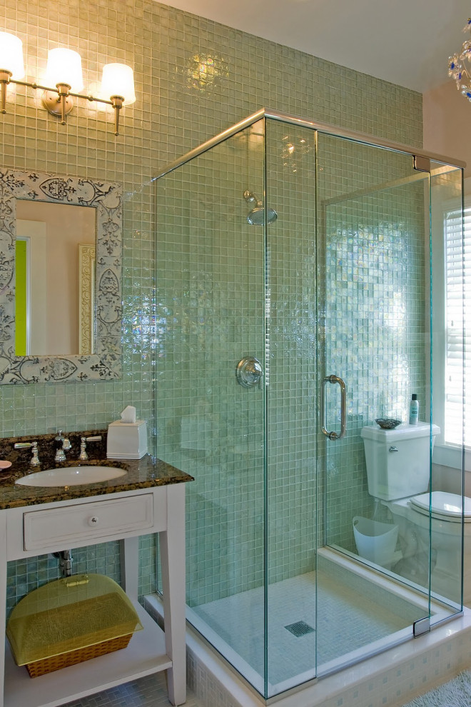 Green-tiled bathroom with glass shower enclosure in Key West renovation