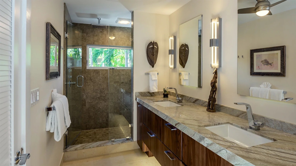 Luxury bathroom with glass shower enclosure and marble countertops in Key West renovation