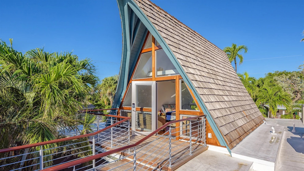 Modern Polynesian-inspired house with pointed roof and tropical landscaping in Key West