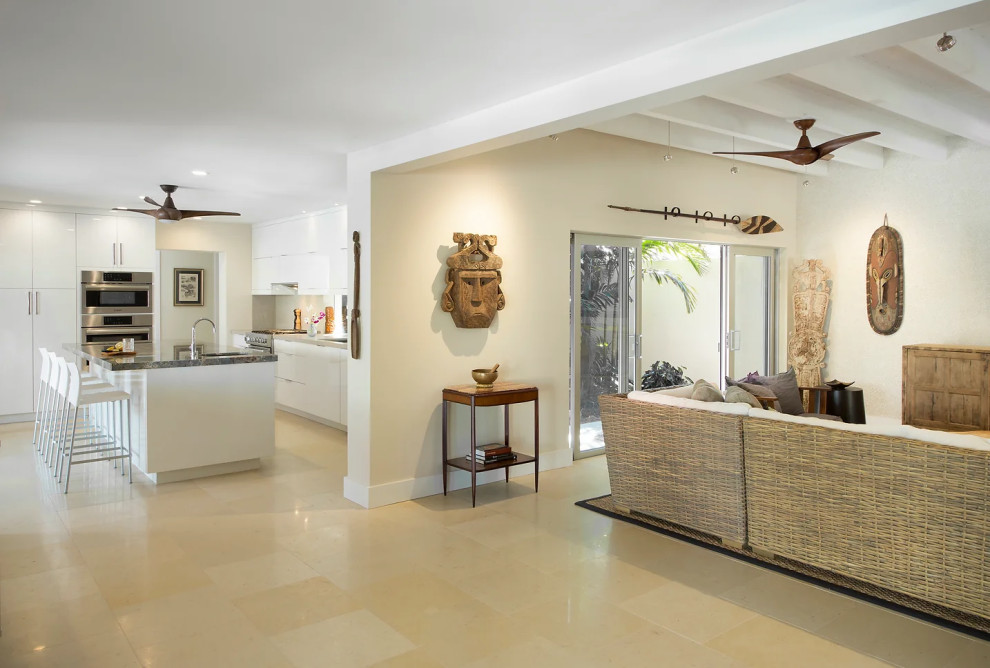 Spacious kitchen with center island and woven wall divider in Key West renovation