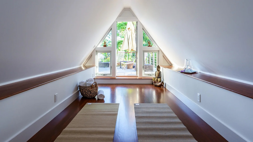 Modern entryway with sloping ceiling and hardwood flooring in Key West renovation