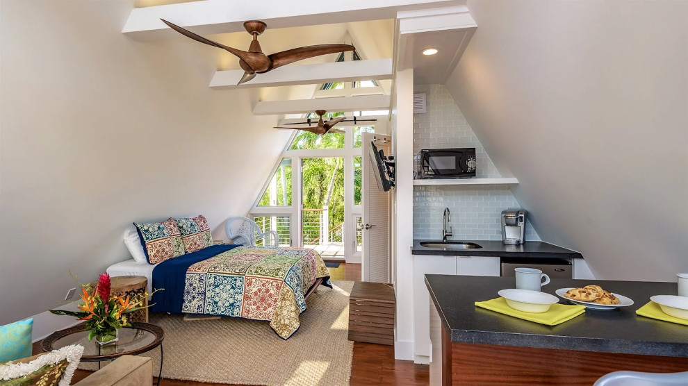 Open-plan living space with ceiling fan and patterned furnishings in Key West renovation