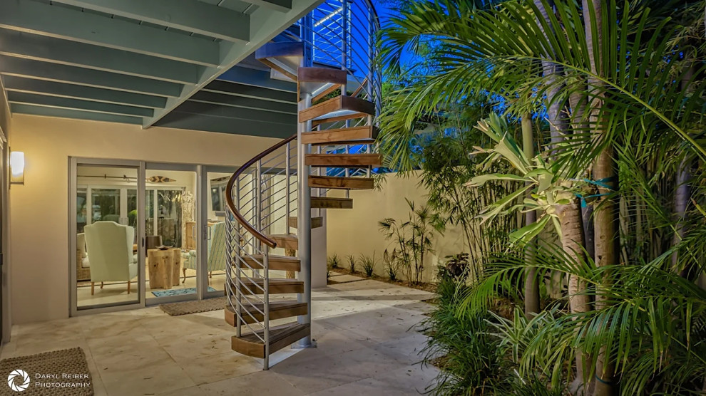 Modern interior with spiral staircase and indoor-outdoor living concept in Key West renovation