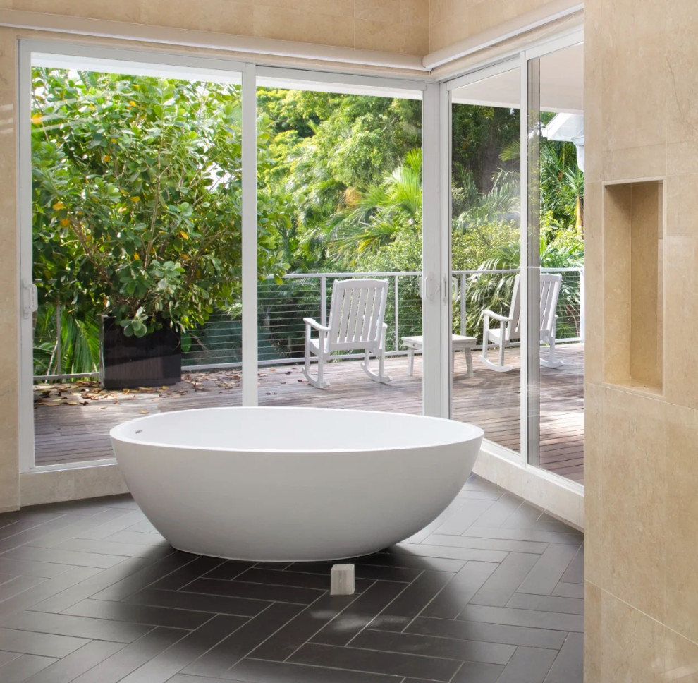 Modern white bathtub with sliding glass doors to outdoor deck in Key West renovation