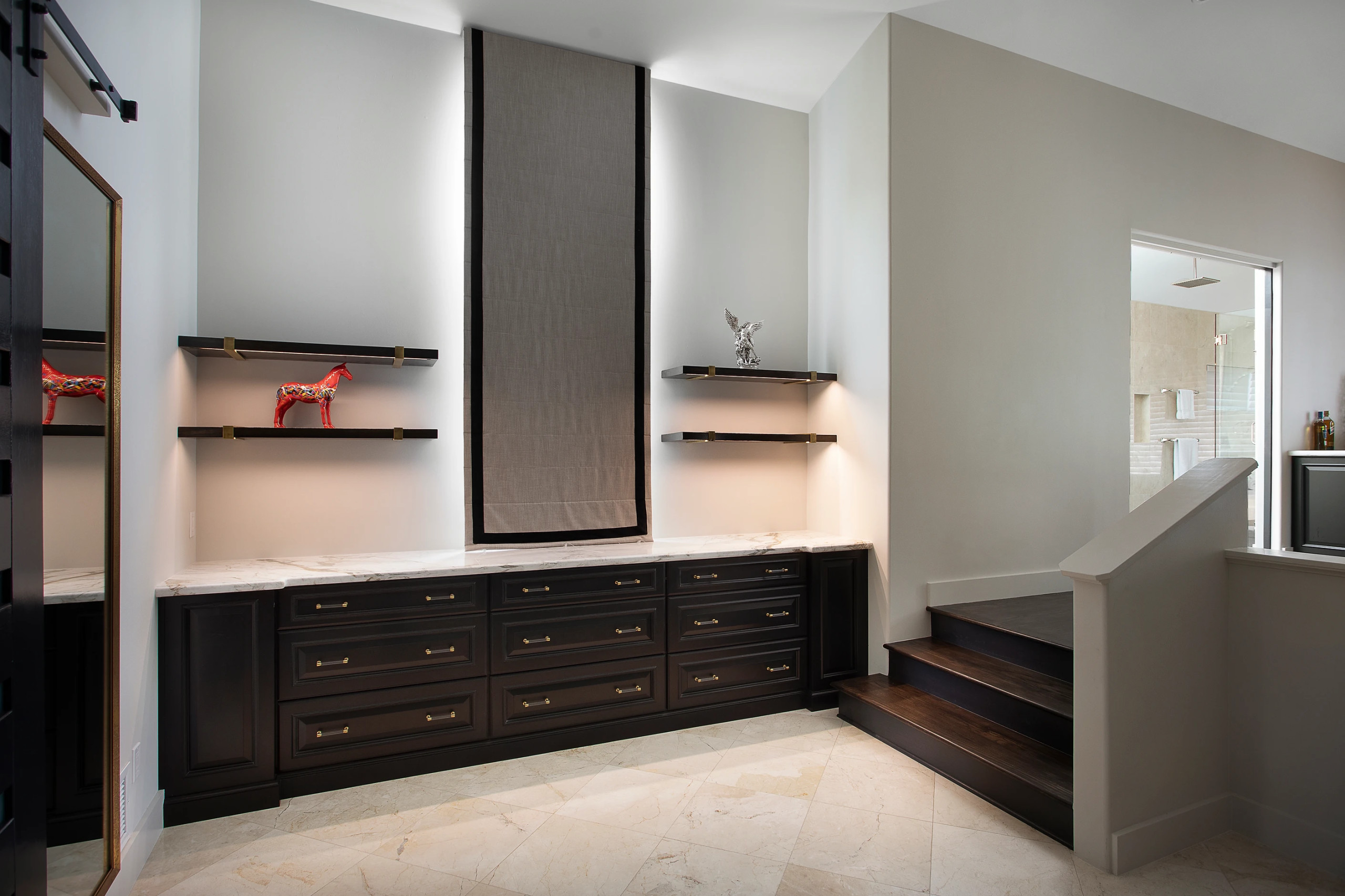 Modern bedroom with custom dark wood cabinetry and architectural details in Key West renovation