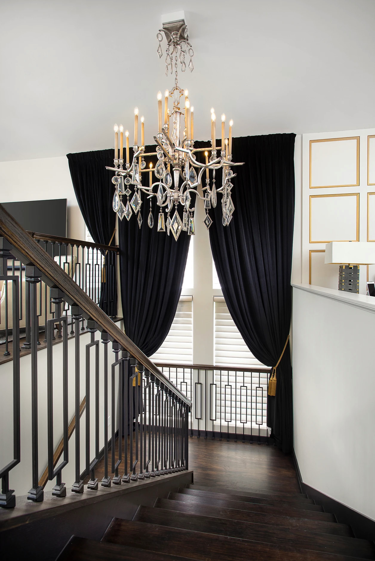 Elegant staircase with custom railing and chandelier in Key West renovation project