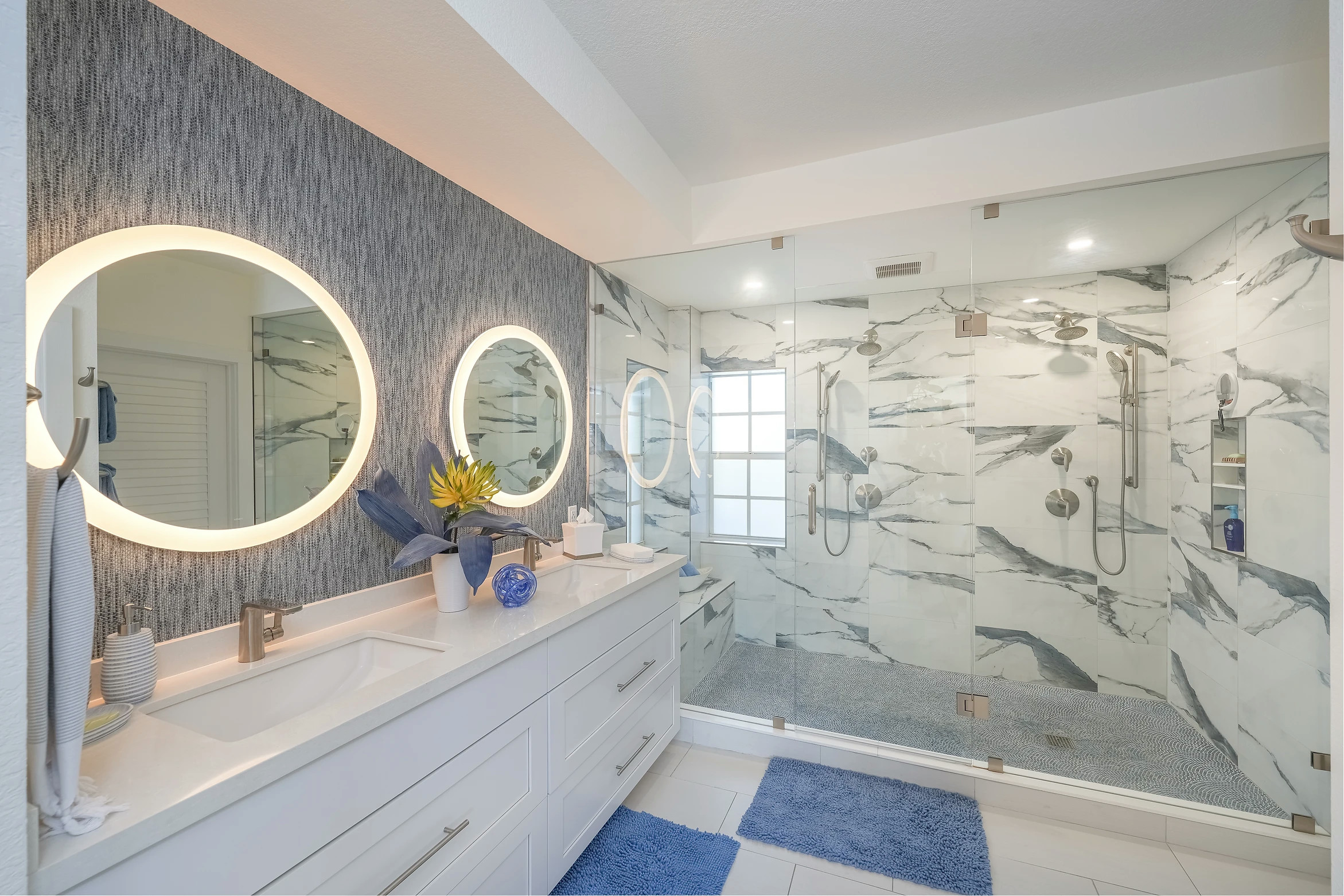 Stylish bathroom with designer mirrors and geometric pattern wallpaper at Sunset Marina