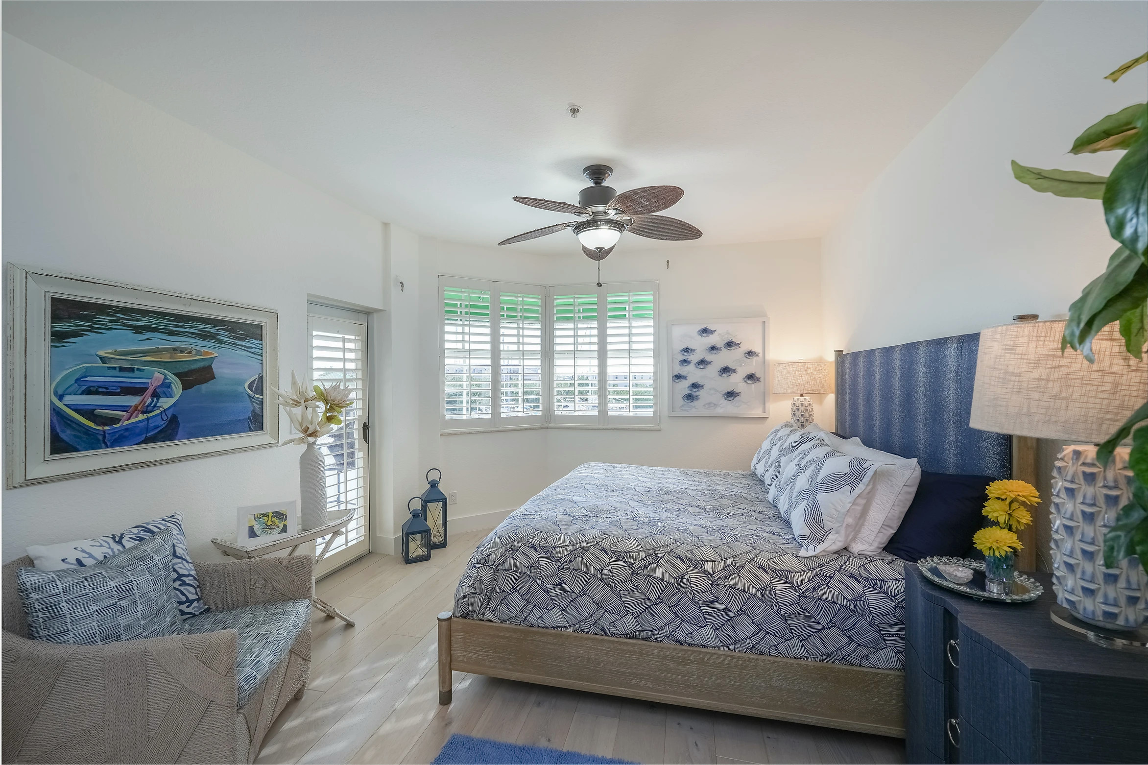 Modern coastal bedroom with blue and white color scheme and nautical accents at Sunset Marina