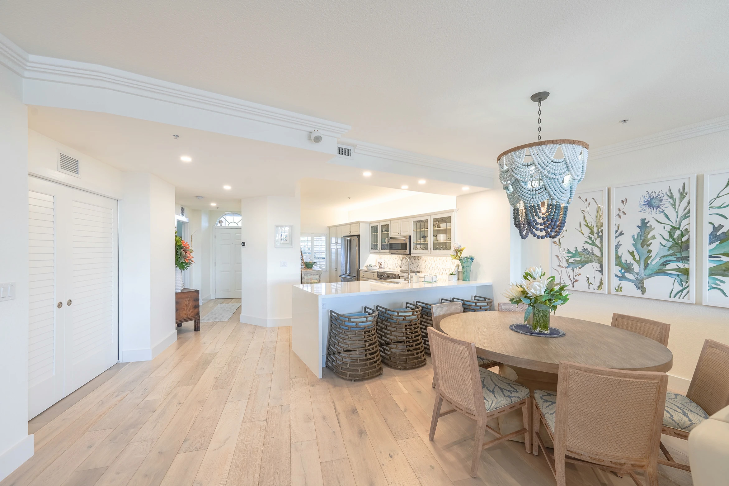 Open concept kitchen with white cabinetry and blue countertop island at Sunset Marina